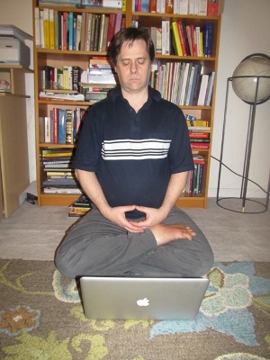 Todd in half-lotus with laptop