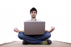 Man sitting cross-legged with laptop, doing that lotusy thing with his hands